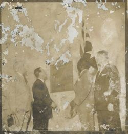 President William V. S. Tubman stands with others in front of the Harvey S. Firestone plague
