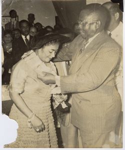 President William V. S. Tubman honors a young woman the Humane Order of African Redemption