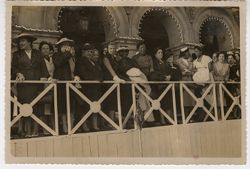 Mrs. Antoinette Tubman stands at a railing with a large group of women