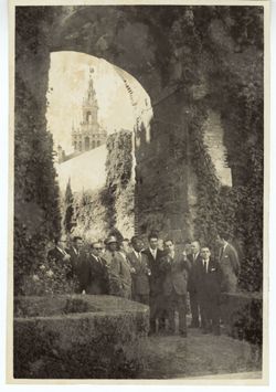 President Tubman and a group of dignitaries stand in an archway with the Seville Cathedral in the background
