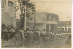 Young girls in uniforms march in parade on Ashmun Street in front of Executive Pavilion