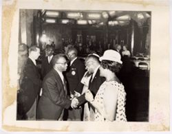 Group stands in line and shake hands