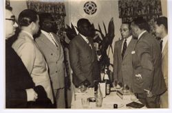 Dignitaries talk while gathered around a table
