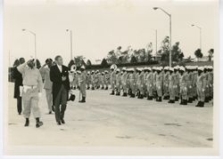 Military officials and dignitaries salute military men