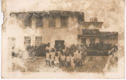 Portrait of children gathered in front of building