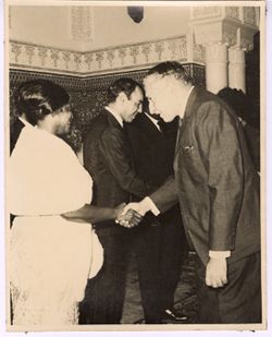 Mrs. Tubman shakes hands with a dignitary