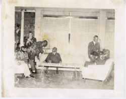 President William V. S. Tubman sits on couch during a tour break