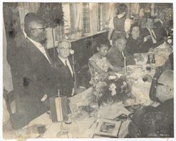 President William V. S. Tubman stands and speaks to guests at table during reception