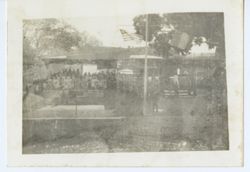 Crowd gathered on shore displaying Liberian flags