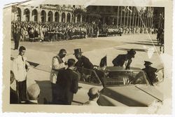 President William V. S. Tubman in formal attire, gets out of convertible during parade