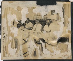 President William V. S. Tubman eating with other men at a reception