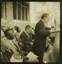 Dignitary speaks into a microphone from behind a lectern