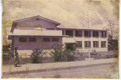 Side view of large, white building and sidewalk
