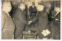 President William V. S. Tubman and man in traditional dress shake hands