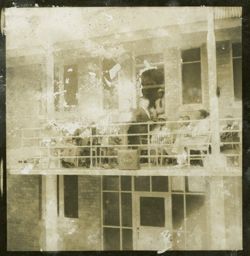 Dignitary stands behind a lectern on a balcony