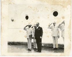 President William V. S. Tubman stands in front of ship and men saluting