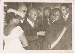 Officials and guests gather around President William V. S. Tubman during a formal reception