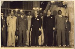 President William V. S. Tubman stands with Alexander Brewer, O. Natty Davis, Charles D. Sherman, Dudley Lawrence, J. Grimes and other officials, on grand staircase