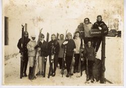 Coocoo Tubman and others in winter dress pose with skis in snow