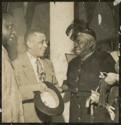 Mary Jane McLeod Bethune, American educator and civil rights leader, converses with guests during a 1952 event honoring President Tubman's inauguration