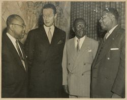 President William V. S. Tubman stands in conversation with three others