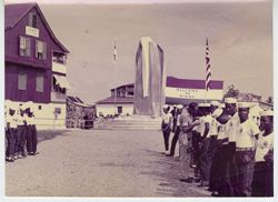 Uniformed men lining up before monument unveiling