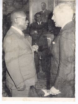 President William V. S. Tubman speaks with an official during an event