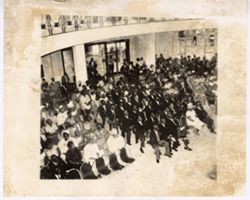 Large crowd in formal dress sit together