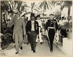 Prime Minister Bustamente, President William V. S. Tubman and Governor Sir Hugh Foot in formal attire walk together