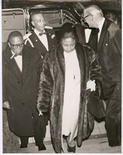 President and Mrs. Tubman leave car with two men