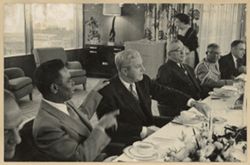 Ambassador Clarence L. Simpson Sr. seated at table with guests at a Luncheon