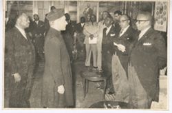 President William V. S. Tubman and others greet man in traditional dress