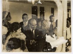 Passengers mingle on the deck of a ship