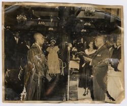 President Tubman reads from a book to a man dressed in ceremonial robes