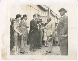 President William V. S. Tubman shakes hands with guest as others stand by
