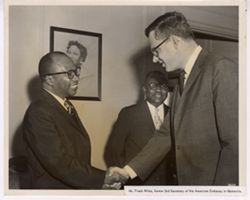 Mr. Frank Wiles, former Second Secretary of the American Embassy in Monrovia shakes hands with another