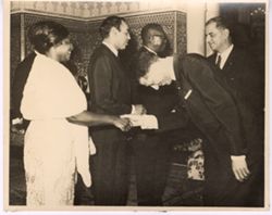 Mrs. Tubman shakes hands with a dignitary