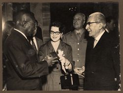 President Tubman admiring souvenir presented to him by officials of Fiat Company