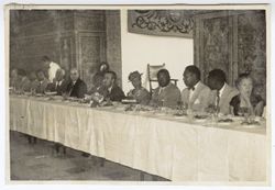 President Tubman seated at dinner with dignitaries in or near Seville, Spain