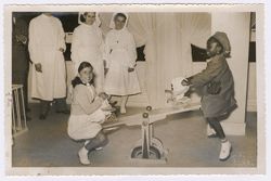 President Tubman's daughter sits on a seesaw with another girl