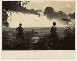 Two men look at waterfall
