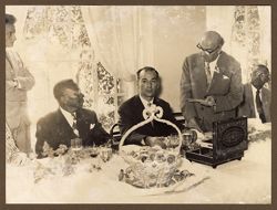 President Tubman listening attentively to a dignitary at luncheon by Tourist Office