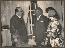 President Tubman stands with a dignitary at a reception