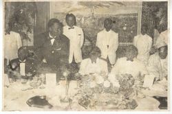 President William V. S. Tubman and others gather around table at formal gathering