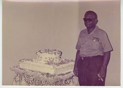 President Tubman posing next to cake