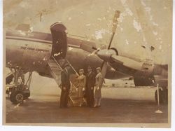 Two men and two women exit airplane