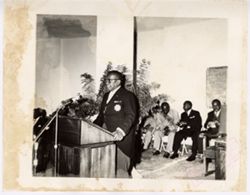 President William V. S. Tubman stands at podium in front of audience