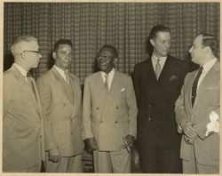 Ambassador Simpson stands with President William V. S. Tubman and others during reception