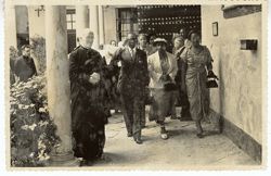 President Tubman, his wife, a clergyman and other dignitaries walk along a patio in or near Seville, Spain