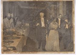 President and Mrs. Tubman walking past buffet table with dignitaries